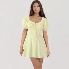Fashionable yellow spring dress with puff sleeves, lace trim, and a fitted waistline, perfect for warm weather and casual or semi-formal occasions.