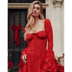 A stunning red lace dress with long sleeves and a bow detail, perfect for holiday celebrations. Elegant and stylish, ideal for Christmas or special occasions.