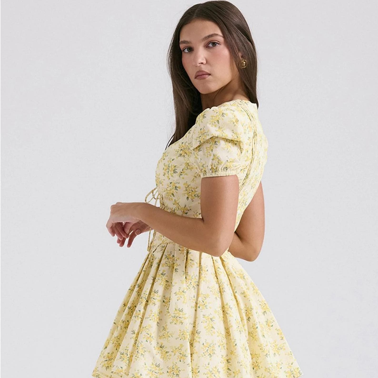 Stylish yellow floral dress with puff sleeves, perfect for casual or semi-formal occasions, emphasizing optimal comfort and fashion.