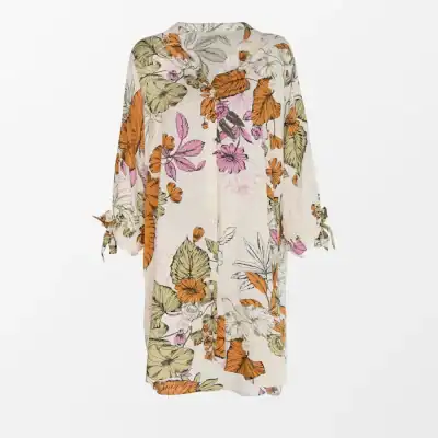 Women’s floral kaftan with vibrant orange, pink, and green botanical print, perfect for summer beach or casual wear, available at Monalisa Medical Store, your destination for stylish resort wear.