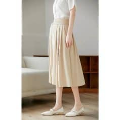 Stylish beige pleated midi skirt paired with elegant shoes, perfect for women's fashion and office wear, showcasing high-quality fabrics and sophisticated design.