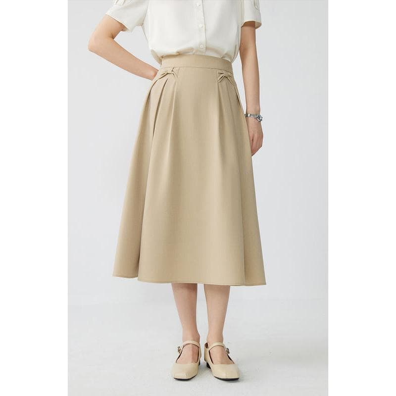 Stylish beige midi skirt with pleats, ideal for office or casual wear, made from comfortable fabric for a flattering fit.