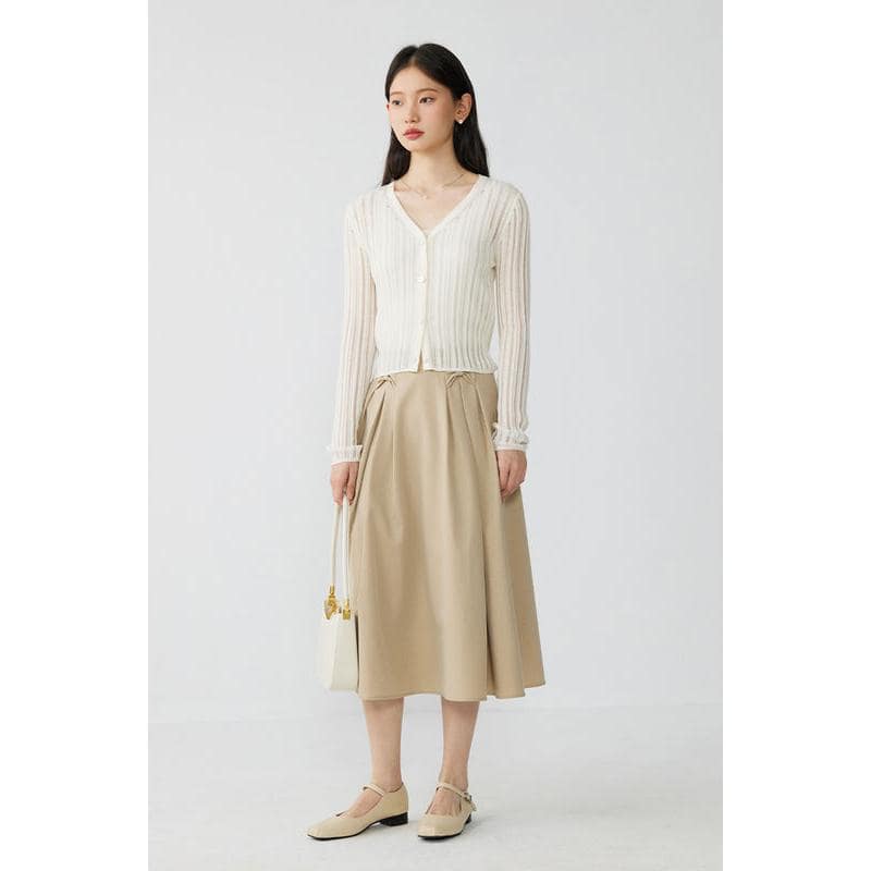 High-quality women's stylish cream cardigan with button details, paired with a beige midi skirt for a sophisticated look. Perfect for casual or semi-formal occasions.
