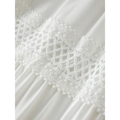 Delicate white lace with intricate embroidery and pom-pom trim, perfect for bridal gowns and elegant clothing. High-quality linen fabric offers a soft, luxurious feel for special occasions.
