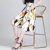 Stylish women's high-waisted skirt with bold geometric print, paired with black high heels, perfect for fashion-forward looks and casual or formal outings.