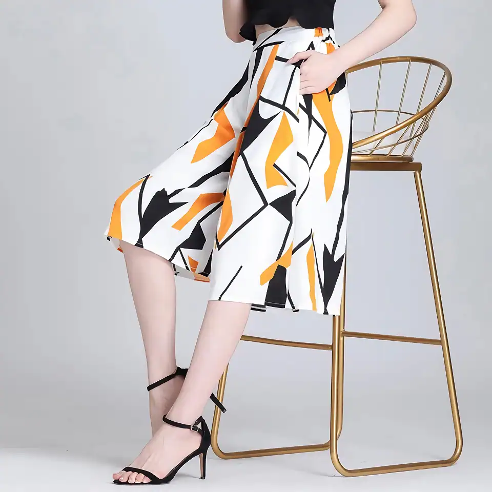 Stylish women's high-waisted skirt with bold geometric print, paired with black high heels, perfect for fashion-forward looks and casual or formal outings.