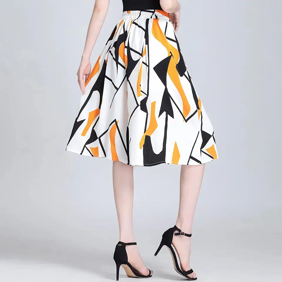 Elegant women's fashion skirt with bold black, white, and orange abstract patterns, perfect for stylish looks and versatile occasions.