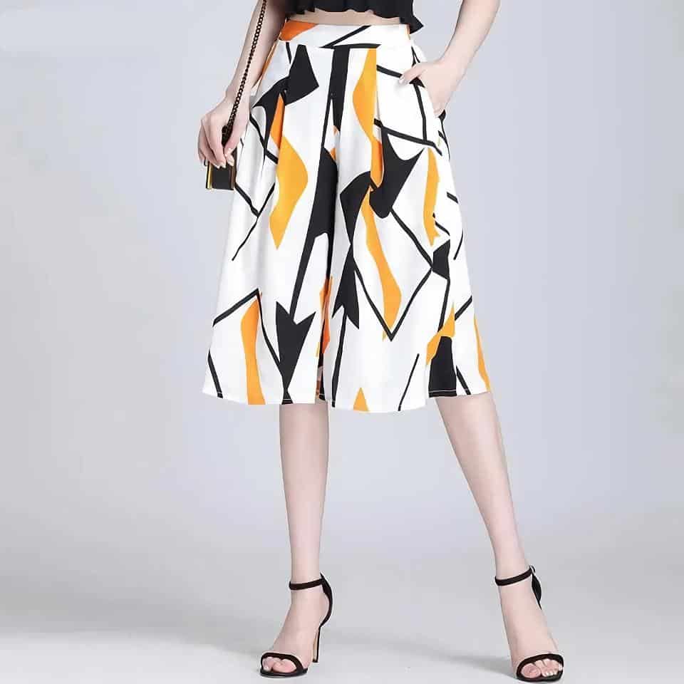 Women's wide-leg geometric patterned pants with black, yellow, and white abstract design. Perfect for stylish, modern fashion and casual or semi-formal occasions.