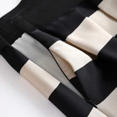 Stylish black and white striped dress, perfect for elegant occasions, featuring a flattering fit and modern design. Quality fabric ensures comfort and durability for versatile wear.