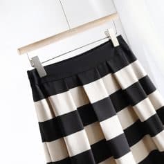 Elegant black and white striped pleated skirt for women, perfect for office or casual wear. Made with comfortable, high-quality fabric for a stylish and versatile look.
