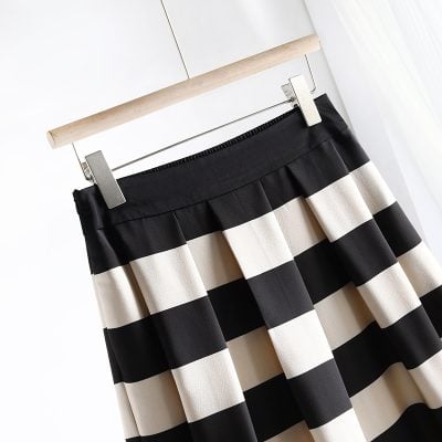 Elegant black and white striped pleated skirt for women, perfect for office or casual wear. Made with comfortable, high-quality fabric for a stylish and versatile look.