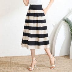 Stylish high-waisted midi skirt featuring bold black and white horizontal stripes, perfect for casual or semi-formal occasions. Made from comfortable, high-quality fabric for a fashionable look.