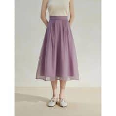 Luxurious lavender midi skirt featuring pleats and sheer overlay, perfect for stylish occasions and office wear. Crafted with high-quality fabric for comfort and elegance.