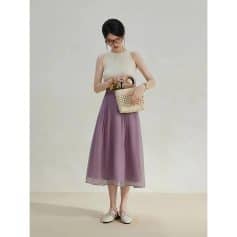 Beautiful woman wearing stylish pastel-colored dress with fashionable accessories, perfect for summer or casual outings. Shop trendy women's clothing, accessories, and bags at Monalisa Store for a chic look.