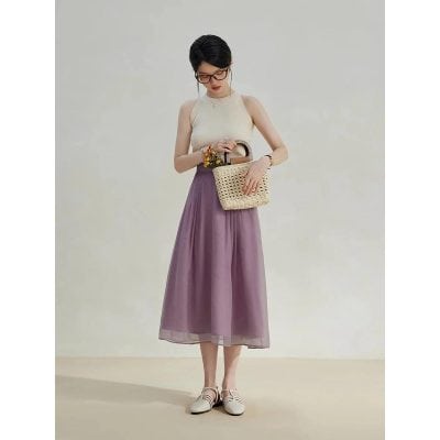 Beautiful woman wearing stylish pastel-colored dress with fashionable accessories, perfect for summer or casual outings. Shop trendy women's clothing, accessories, and bags at Monalisa Store for a chic look.