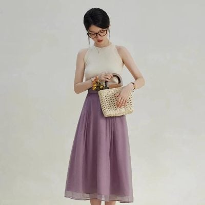 Chic women's outfit featuring a flowy purple maxi skirt and sleeveless top, ideal for fashionable summer looks, casual day out, or shopping trips.