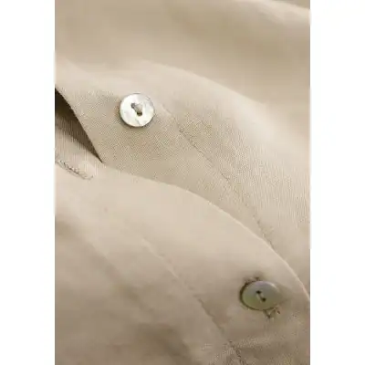 Light beige, tailored dress shirt with pearl buttons, perfect for professional or formal occasions. Excellent quality, stylish, and comfortable for men seeking refined eyewear and fashion accessories.