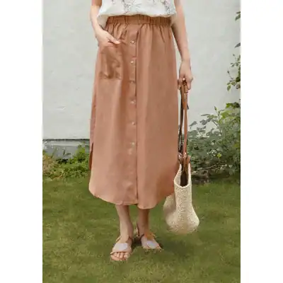 Elegant long beige satin skirt with button details, flowy design, and comfortable fit for women. Perfect for casual or dressy occasions.