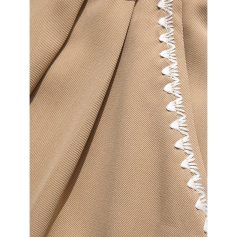 Close-up image of a beige surgical drape with white trim, used in medical settings for surgical procedures and protection of sterile environments.