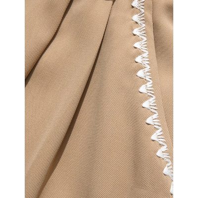 Close-up image of a beige surgical drape with white trim, used in medical settings for surgical procedures and protection of sterile environments.