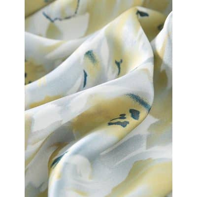 Luxurious floral scarf featuring a delicate pastel yellow and blue floral pattern, ideal for stylish accessories and versatile fashion looks.