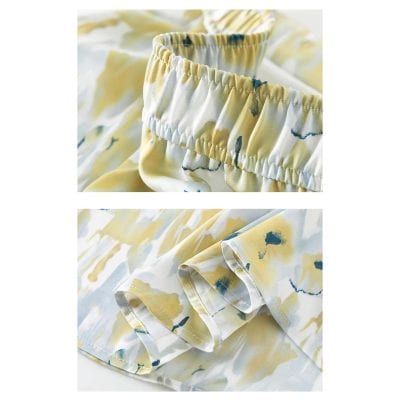 High-quality women's pajama set featuring a floral pattern, comfortable ruffled waistband, and silky satin cuffs for a luxurious sleep experience. Perfect for lounging or sleeping in style.