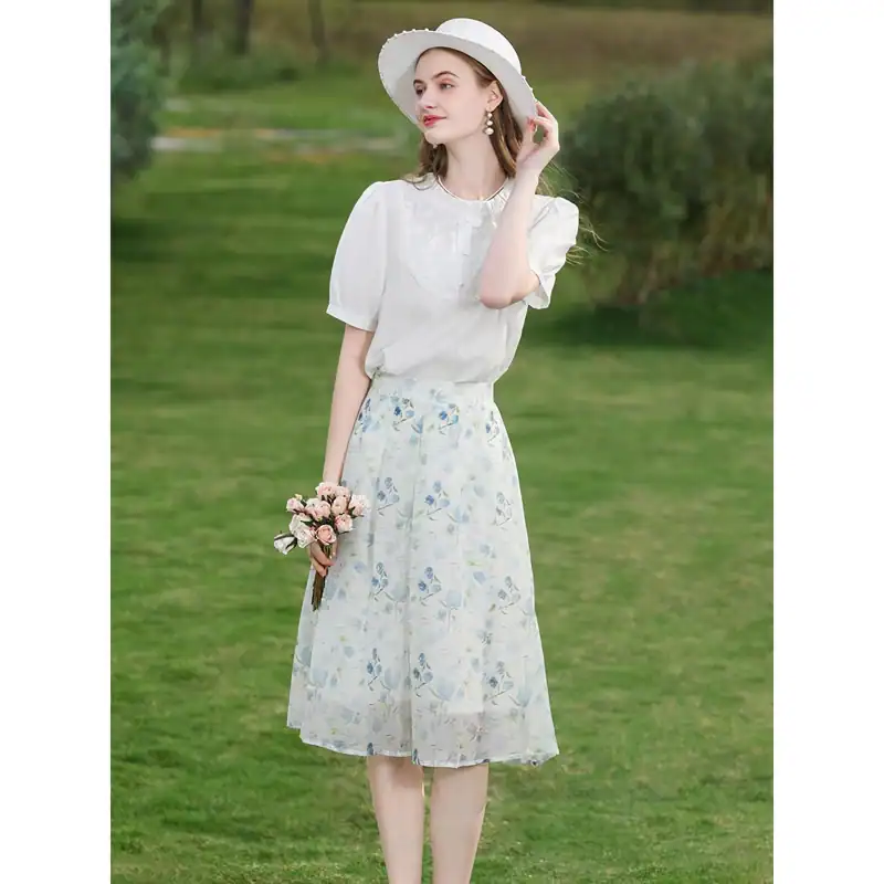 Elegant white summer dress with floral pattern, perfect for outdoor occasions and garden parties, featuring a flattering midi length and lightweight fabric.