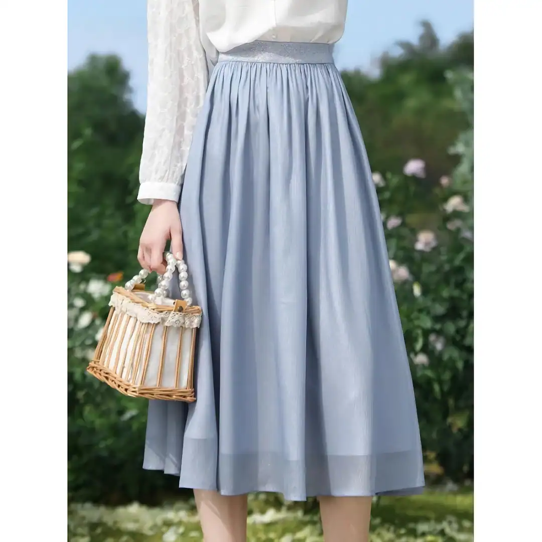 A stylish light blue midi skirt featuring a high waist, flowy design, perfect for casual or semi-formal wear, available at Monalisa Medical Store.