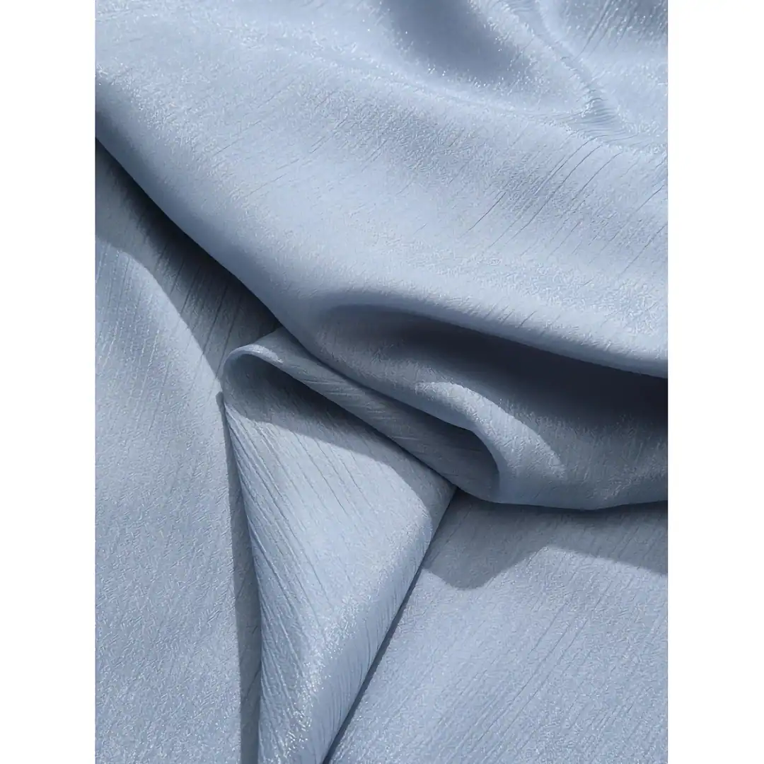 High-quality, luxurious blue silk fabric ideal for premium cosmetic and skincare product packaging, offering a smooth and shiny surface to enhance product presentation.