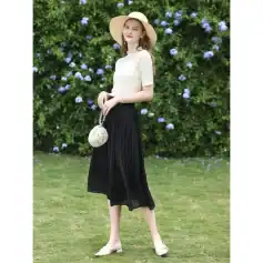 Stunning woman in a chic summer dress, stylish hat, and accessories outdoors, highlighting fashionable women's clothing for versatile looks at Monalisa Medical Store.