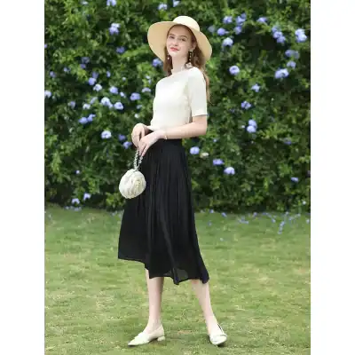 Stunning woman in a chic summer dress, stylish hat, and accessories outdoors, highlighting fashionable women's clothing for versatile looks at Monalisa Medical Store.