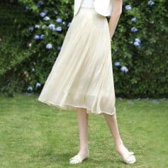 Light beige pleated midi skirt perfect for casual or semi-formal occasions. Comfortable fit with flowy design, ideal for spring and summer wear.