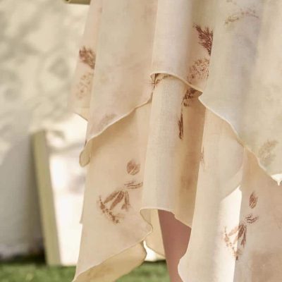 Soft beige linen dress featuring subtle leaf patterns, perfect for summer wear, casual outings, or relaxed events. Comfortable and stylish, ideal for those seeking breathable and fashionable clothing options.