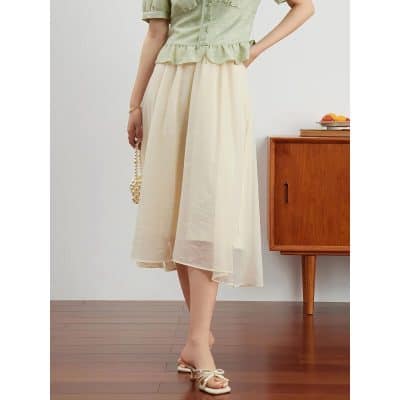 A stylish women's summer skirt displayed with a pastel green top and beige shoes, highlighting fashionable casualwear options.