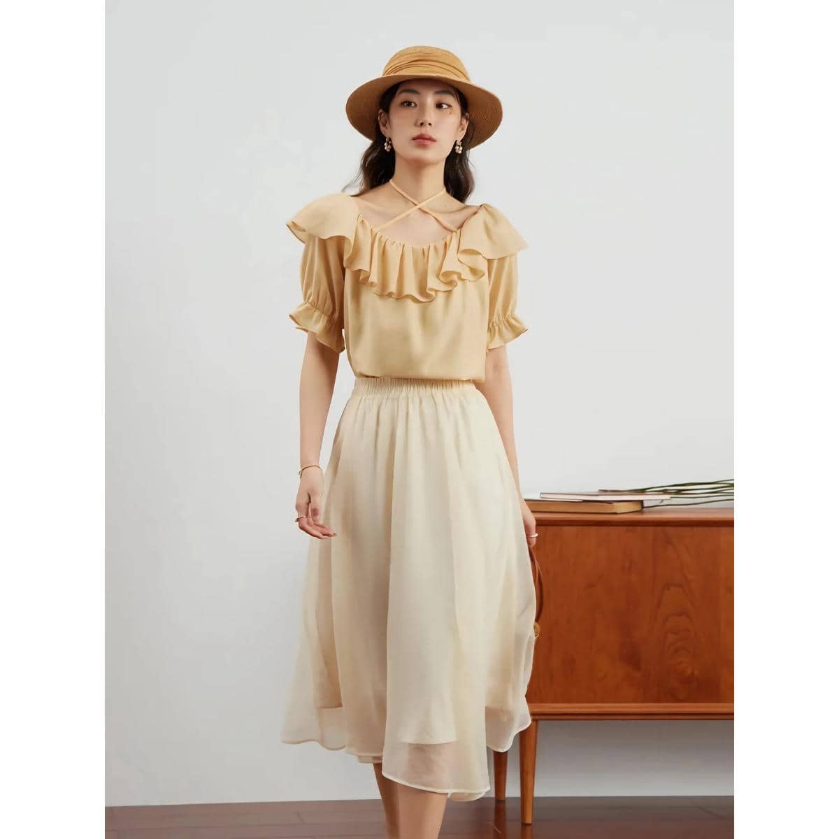 Stylish beige dress with ruffle details and matching wide-brim hat, perfect for summer casual or resort wear. Featured on Monalisa Medical’s fashion collection for women.
