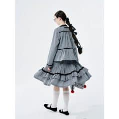 Stylish gray dress with layered ruffles and black accents, perfect for fashion-forward women seeking a chic, modern look.