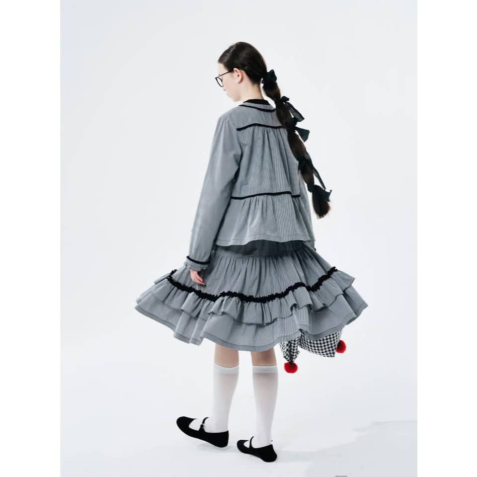 Stylish gray dress with layered ruffles and black accents, perfect for fashion-forward women seeking a chic, modern look.