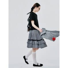 Women wearing trendy glasses in a stylish, minimalist setting for fashionable eye care.