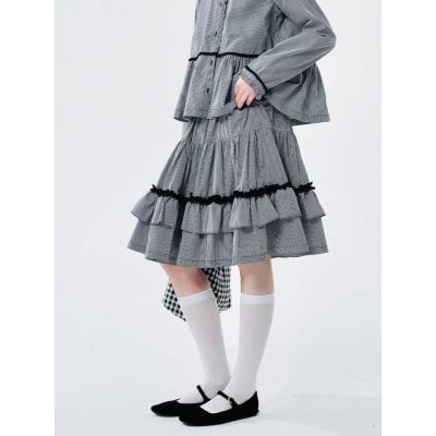 Elegant women's fashion skirt featuring a unique tiered design, black trim details, and comfortable length, perfect for casual or dressy occasions.