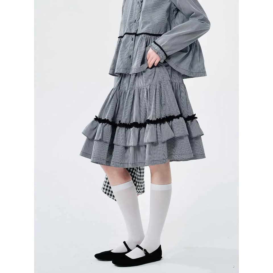 Elegant women's fashion skirt featuring a unique tiered design, black trim details, and comfortable length, perfect for casual or dressy occasions.