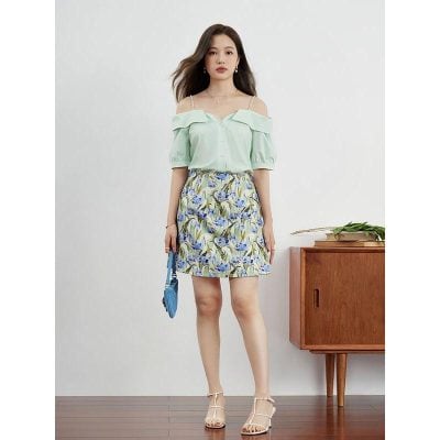Elegant women's fashion outfit featuring a breezy mint green off-shoulder blouse and colorful floral skirt, available at Monalisa Store for trendy summer style.