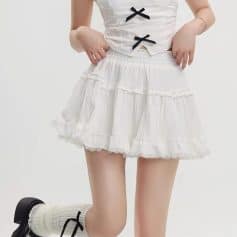 White lace skirt, stylish and feminine casual wear perfect for spring and summer outfits. Made of lightweight fabric with ruffle details, ideal for young women seeking trendy and comfortable clothing options.