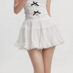 Lightweight white skirt with ruffle details, perfect for casual or dressy occasions. Comfortable elastic waistband and feminine design ideal for summer wardrobe essentials.