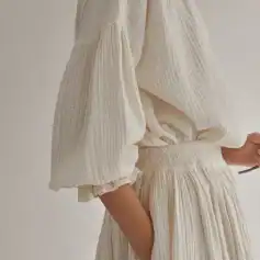 Elegant cream-colored textured linen jogger set with puffed sleeves, elastic waist, and relaxed fit, perfect for stylish everyday wear or lounging.