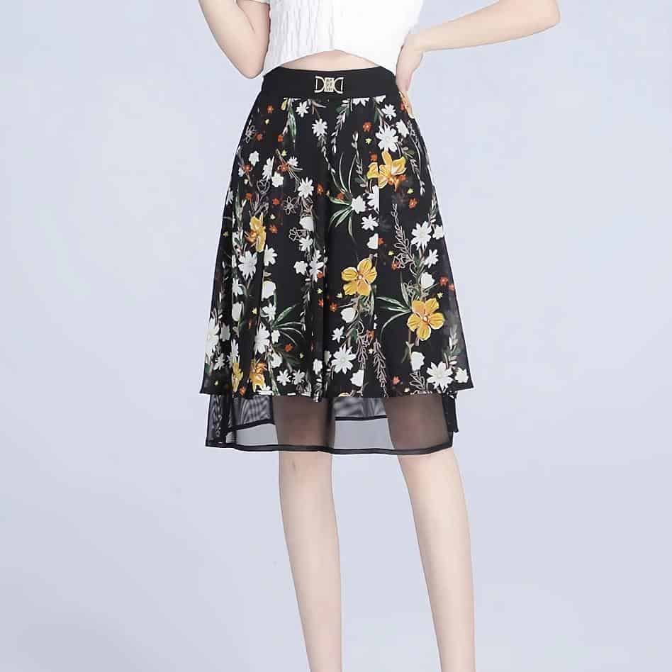 Stylish women's floral midi skirt with black background and layered sheer hem, perfect for fashion-forward looks and comfortable wear.