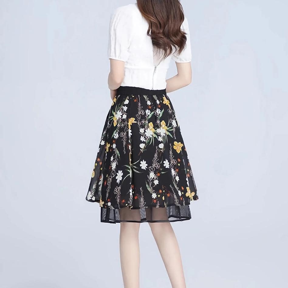 Bright floral design on a black background, ideal for enhancing your wardrobe with trendy, versatile fashion pieces.
