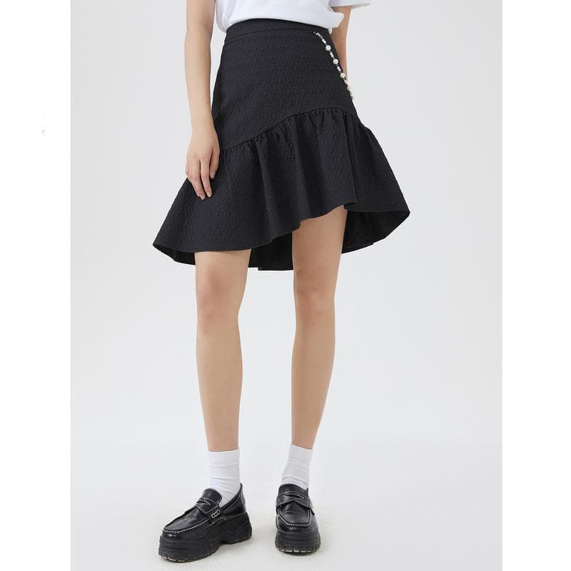 Stylish black women’s skirt featuring ruffle hem, textured fabric, and pearl embellishments for a trendy look.