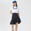 Stylish young woman wearing casual city fashion with white t-shirt, black ruffled skirt, and blue cap. Perfect local fashion look from Monalisa Store for trendy daily wear.