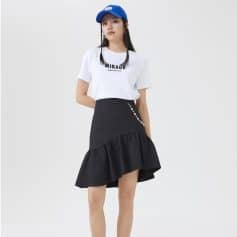Stylish young woman wearing casual city fashion with white t-shirt, black ruffled skirt, and blue cap. Perfect local fashion look from Monalisa Store for trendy daily wear.