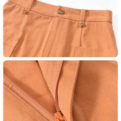 Close-up of peach-colored tailored pants featuring a zipper detail and fine stitching, showcasing high-quality fabric and craftsmanship for fashionable, comfortable wear.